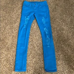 Distressed blue denim skinny jeans